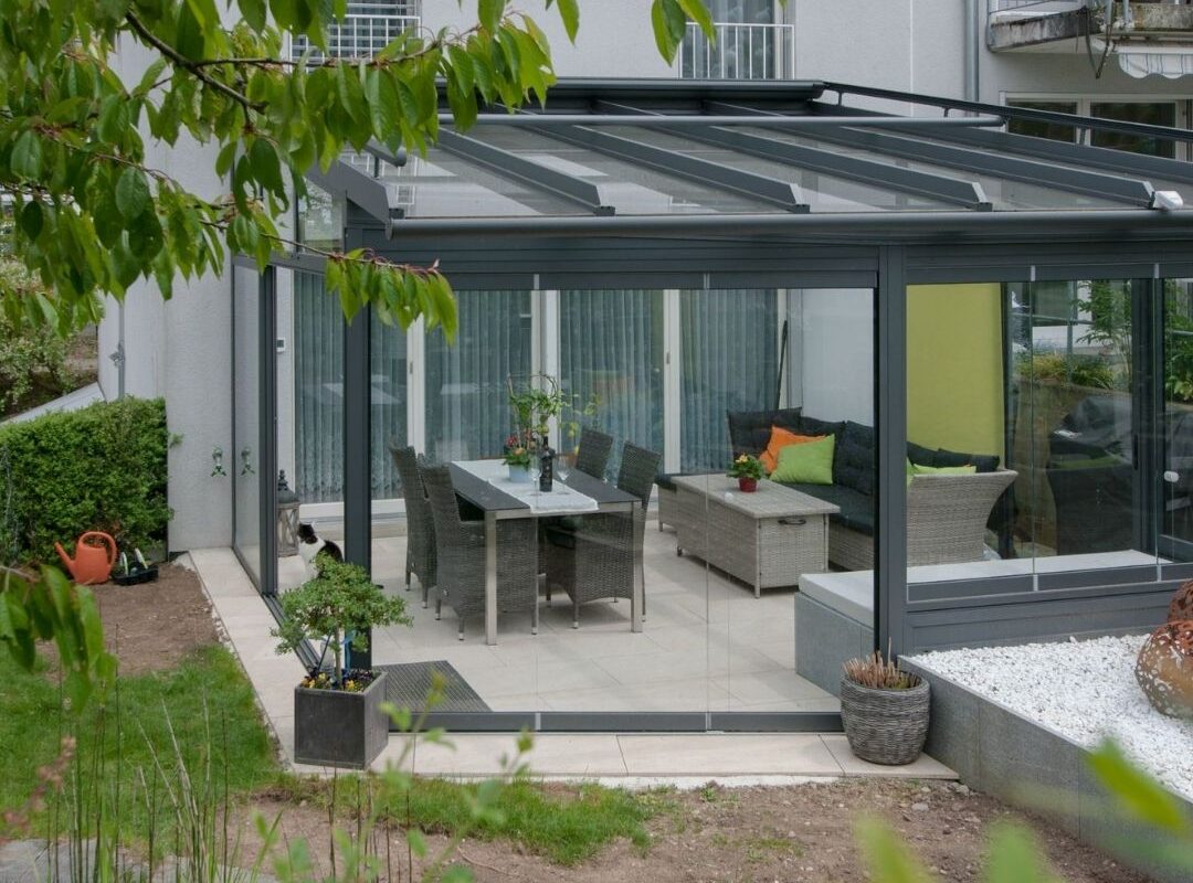 Glasdach Wintergarten in Elsau Zürich mit moderner Einrichtung und Gartenblick