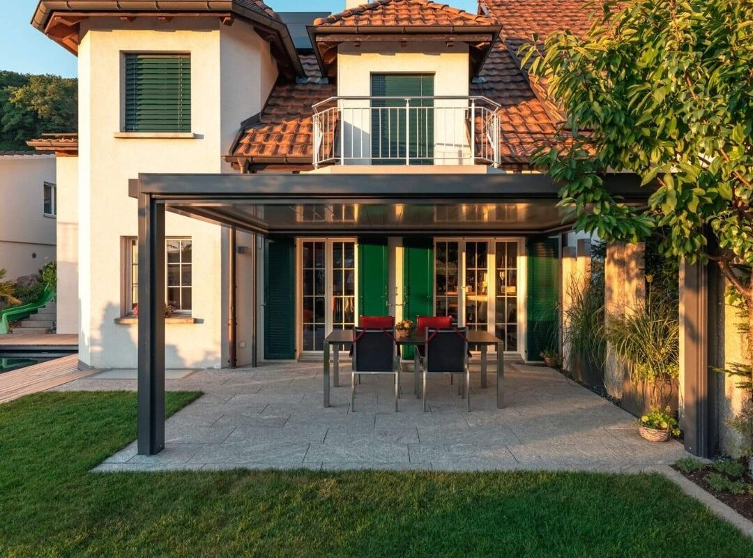 Modernes SKL 150+ Panorama Lamellendach an einem Einfamilienhaus in Niederweningen Zürich mit Essbereich auf der Terrasse.