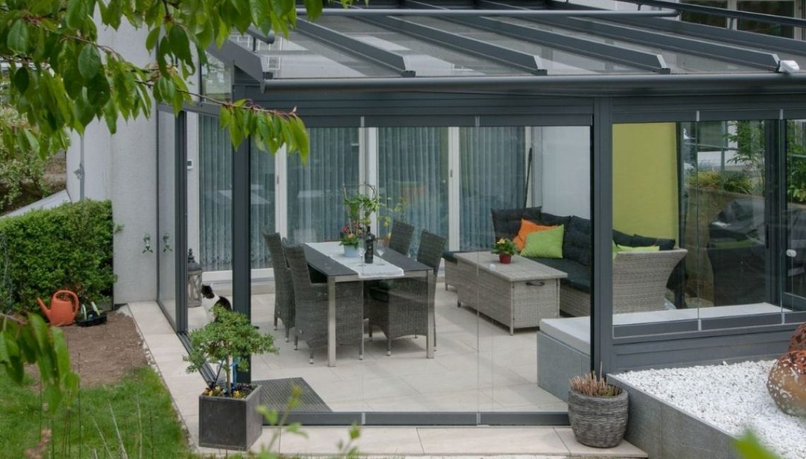 Glasdach Wintergarten in Elsau Zürich mit moderner Einrichtung und Gartenblick