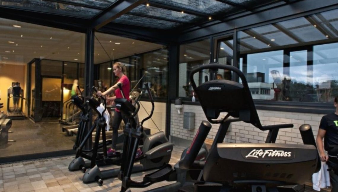 Glasdach von Thermogreen beim AURAVITA Health Club & Day Spa in Rapperswil mit LED-Beleuchtung bei Abendstimmung.