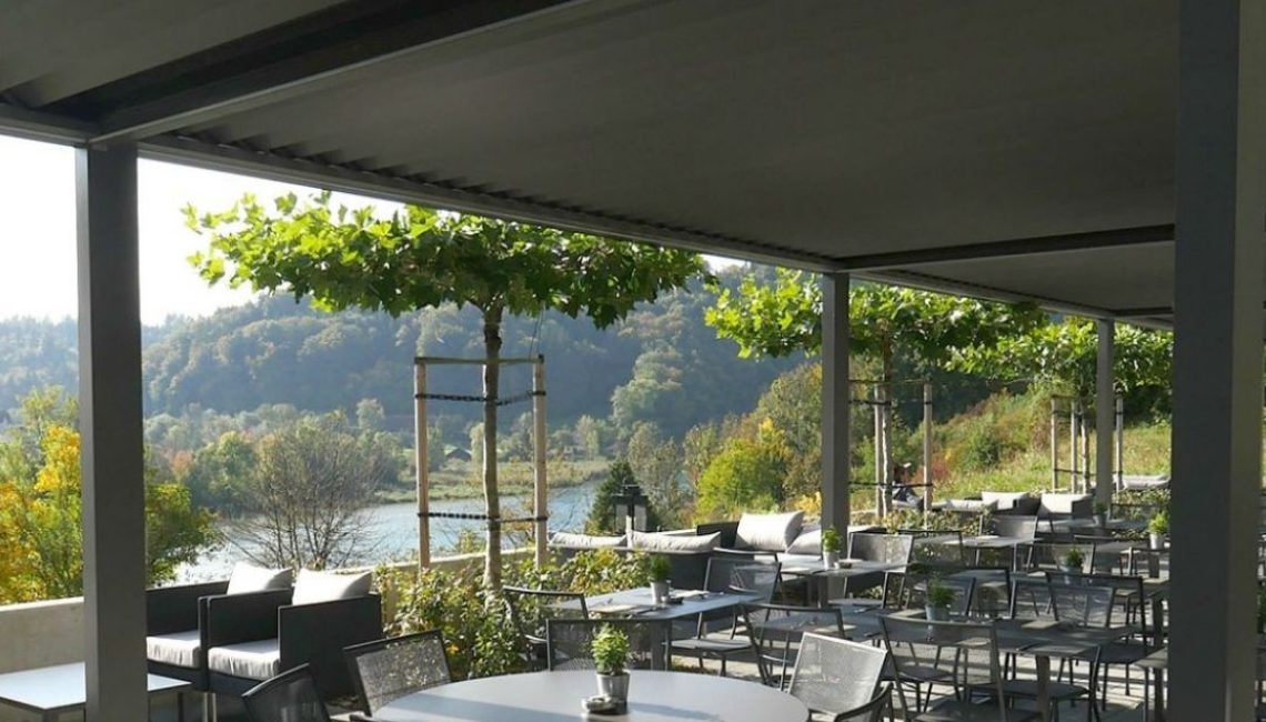 SKL 100 Lamellendach in Hinterkappelen Bern, geschlossene Lamellen bieten zuverlässigen Sonnen- und Regenschutz auf der Terrasse mit Blick zur Aare.