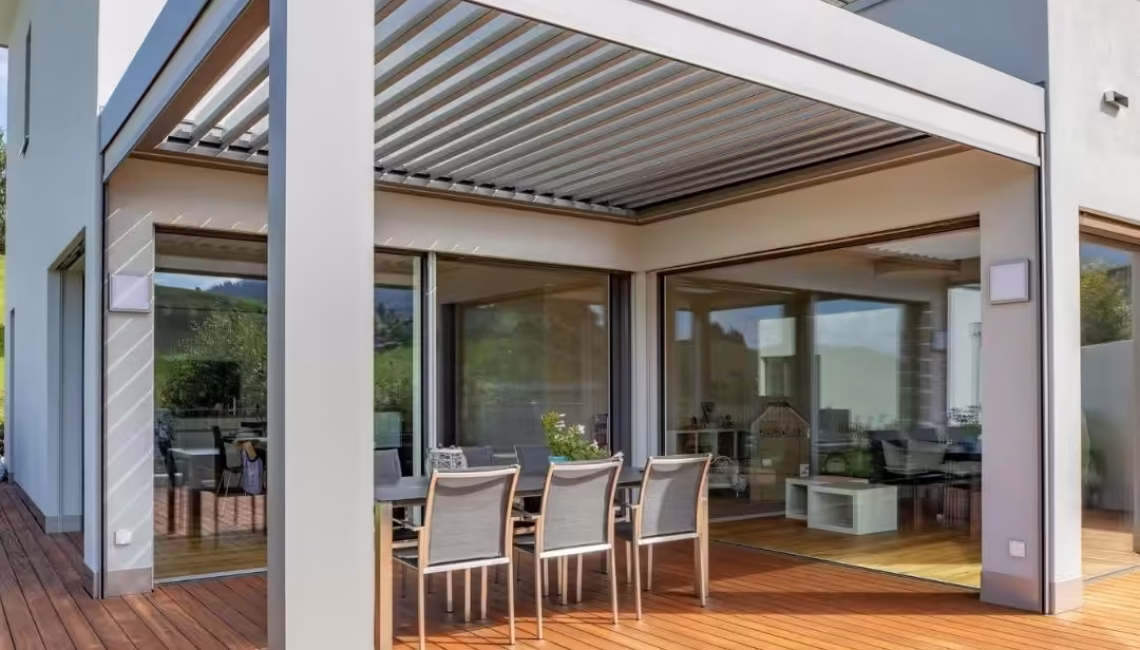 SKL 140 Lamellendach in Schwarzenberg, Luzern – moderne Überdachung mit hellgrauem Aluminiumrahmen und Holzterrasse, ausgelegt für 300 kg/m² Schneelast.