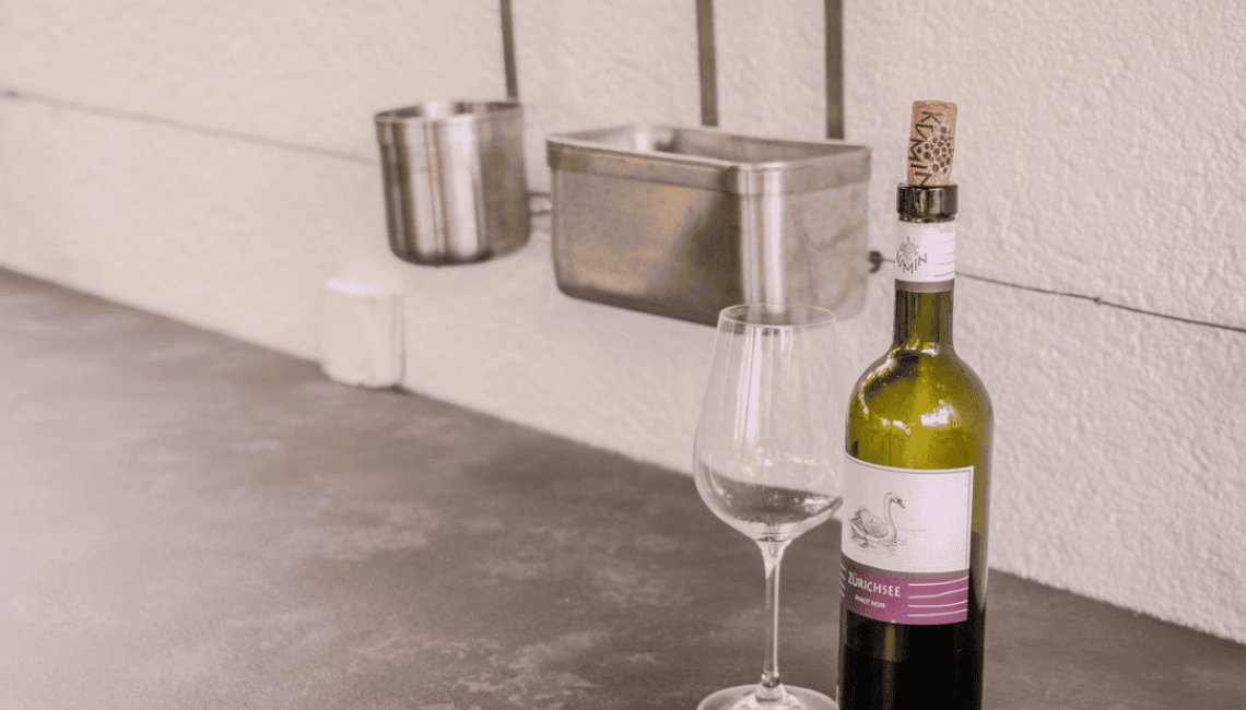 Detail der Aussenküche Theiss Avers in Stäfa mit Arbeitsfläche, Wandreling und abgestellten Küchenutensilien